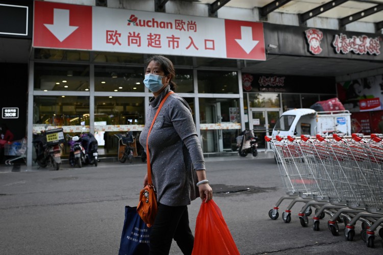 Mulher caminhando em um supermercado de Pequim, na China