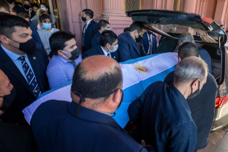 Foto da apostila divulgada pela assessoria de imprensa da Presidência da Argentina mostrando o caixão da falecida lenda do futebol argentino Diego Armando Maradona sendo colocado no carro funerário, em frente à casa do governo Casa Rosada, em Buenos Aires, em 26 de novembro de 2020. - Diego Maradona será sepultado quinta-feira nos arredores de Buenos Aires, disse um porta-voz. Maradona, que morreu de ataque cardíaco na quarta-feira aos 60 anos, será enterrado no cemitério Jardin de Paz, onde seus pais também foram enterrados, disse Sebastian Sanchi à AFP. (Foto: ESTEBAN COLLAZO / Assessoria de Imprensa da Presidência da Argentina / AFP)