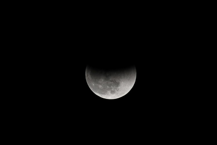 A partial lunar eclipse is seen from the Sijiaoku lookout in New Taipei City on November 19, 2021.