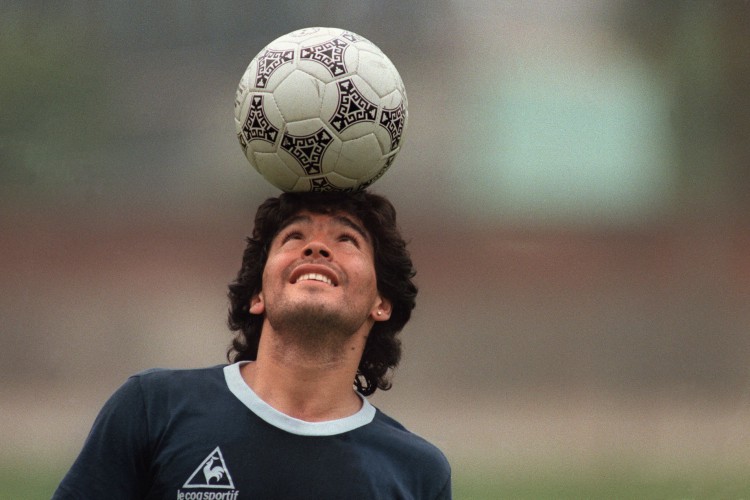 (ARQUIVOS) Nesta foto de arquivo, tirada em 22 de maio de 1986, o astro do futebol argentino Diego Maradona, usando um brinco de diamante, equilibra uma bola de futebol na cabeça enquanto sai do campo de treino após o treino da seleção nacional em 22 de maio de 1986 na Cidade do México . O próximo dia 25 de novembro de 2021 marca o primeiro aniversário da morte de Diego Maradona.
JORGE DURAN / AFP