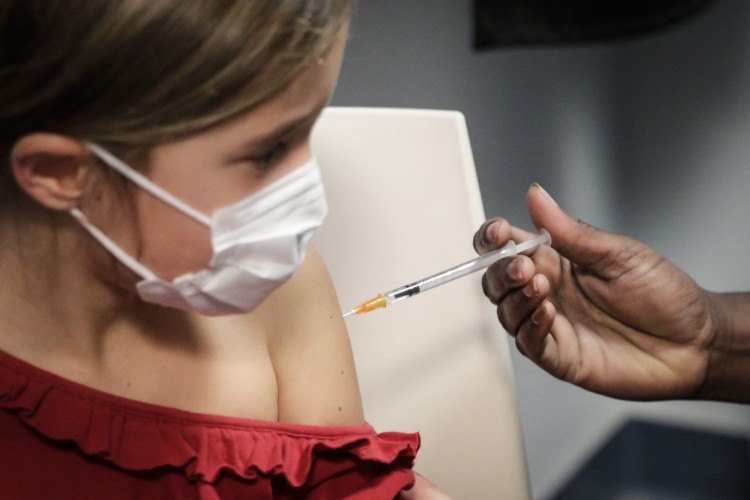 ￼VACINAÇÃO de crianças contra Covid-19 já começou em alguns países. Na foto, menina recebe dose da Pfizer em Paris