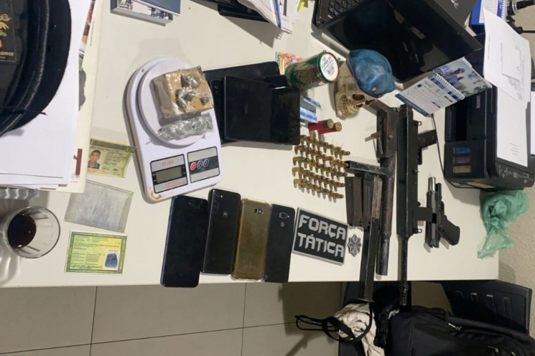 Foram apreendidos duas metralhadoras calibre .40, 400 gramas de maconha, uma pistola calibre .40 e oito aparelhos celulares com dupla