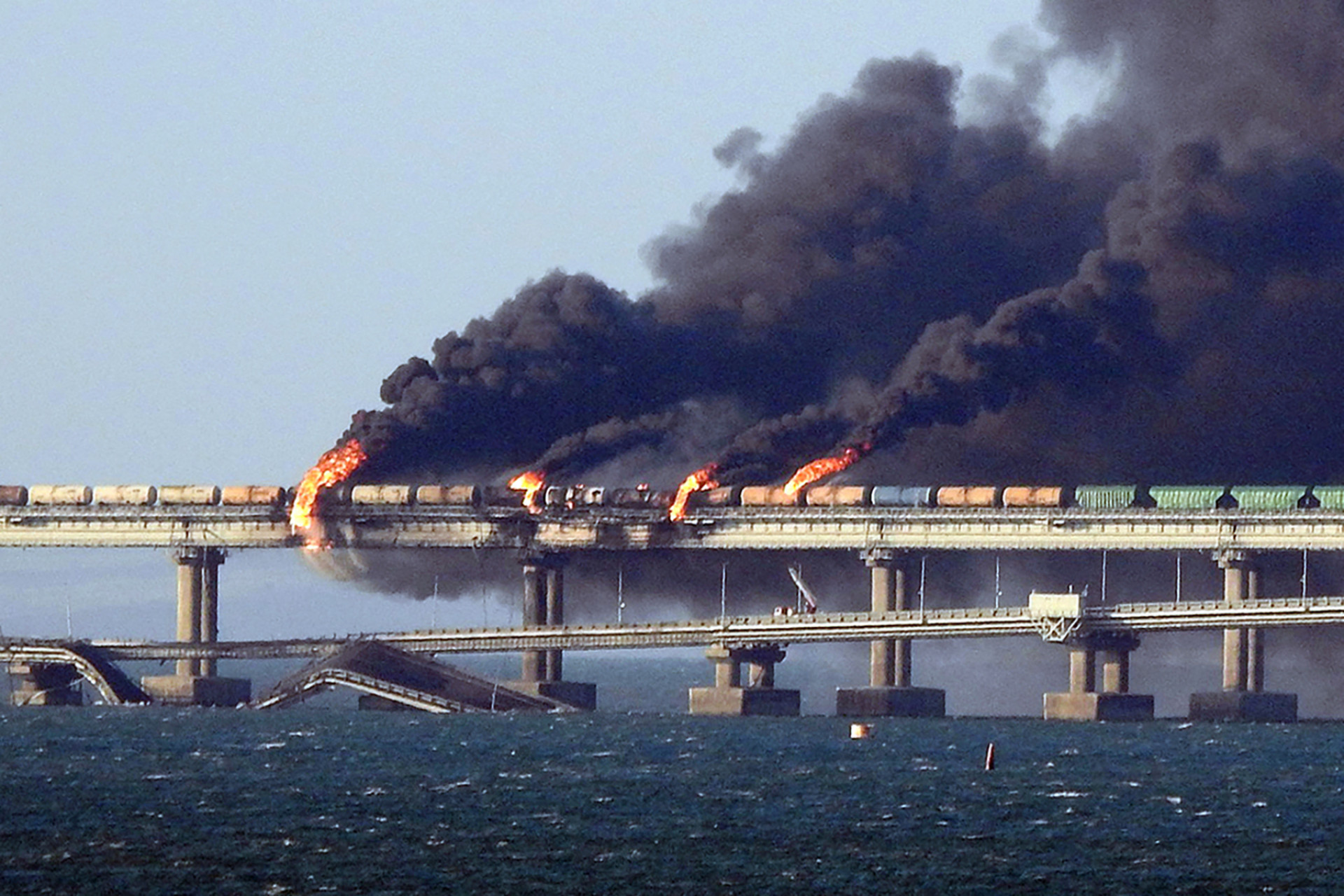 Fumaça preta sobe de um incêndio na ponte de Kerch que liga a Crimeia à Rússia, depois que um caminhão explodiu, perto de Kerch, em 8 de outubro de 2022. Moscou anunciou em 8 de outubro de 2022 que um caminhão explodiu provocando um grande incêndio e danificando a chave Kerch ponte - construída como a única ligação terrestre da Rússia com a Crimeia anexada - e prometeu encontrar os autores, sem culpar imediatamente a Ucrânia.
 (Foto: AFP)