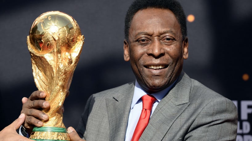 Brazilian football legend Pele poses with the FIFA World Cup trophy on March 9, 2014 in Paris. The FIFA World Cup trophy arrived with its ambassador Pele in Paris on March 9, 2014 and will be exhibited on the Paris Hotel de Ville plaza until March 10. This event kicks off the festivities of the FIFA World Cup 2014, that will be held in Brazil through June 12-July 13, 2014.