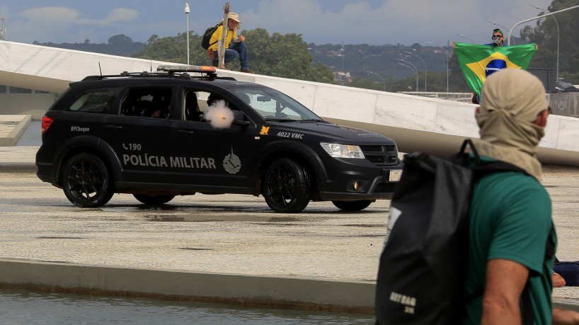 Military Police forces fore tear gas at supporters of Brazilian former President Jair Bolsonaro as they invade Planalto Presidential Palace in Brasilia on January 8, 2023. - Hundreds of supporters of Brazil's far-right ex-president Jair Bolsonaro broke through police barricades and stormed into Congress, the presidential palace and the Supreme Court Sunday, in a dramatic protest against President Luiz Inacio Lula da Silva's inauguration last week. (Photo by Sergio Lima / AFP)