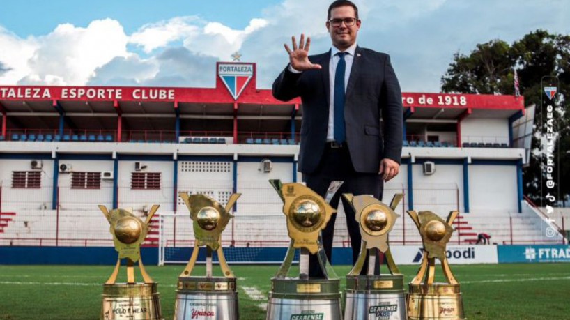 Alex Santiago posa com as cinco taças conquistadas pelo Fortaleza no Campeonato Cearense, de 2019 a 2023