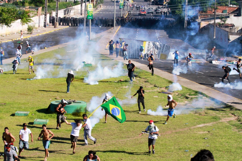 Confronto entre manifestantes e policiais militares na avenida Alberto Craveiro, próximo ao estádio Castelão, em junho de 2013(Foto: Fabio Lima)