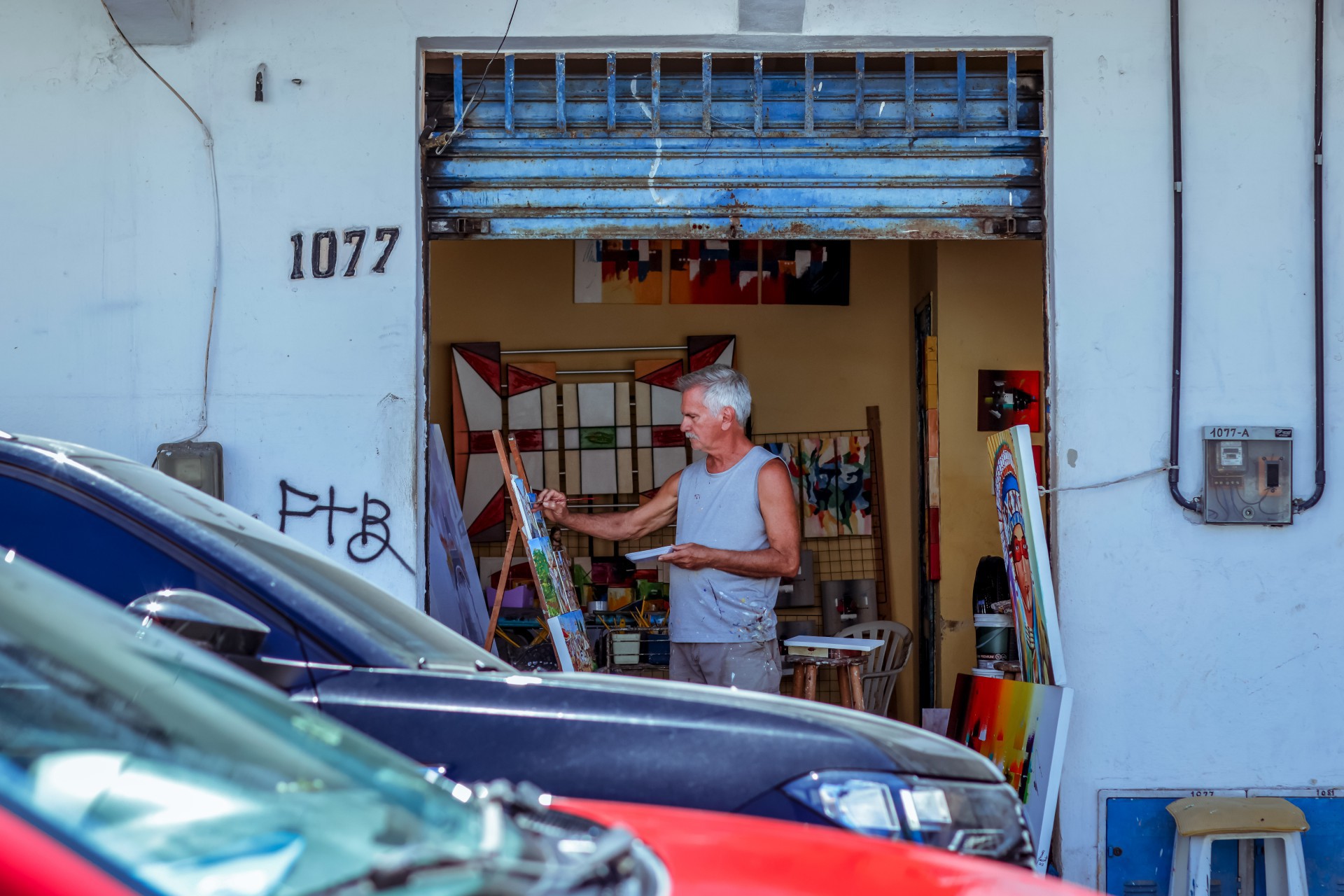 ￼Barulheira dos carros não rouba a concentração do pintor Alfredo Lacet (Foto: AURÉLIO ALVES)