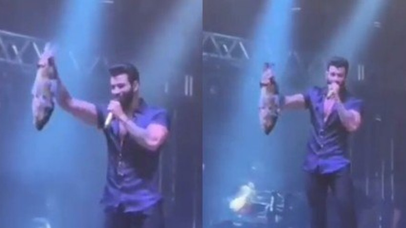 Gusttavo Lima ganha peixe grande de presente durante show