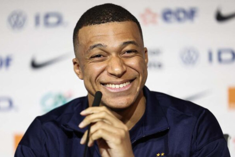 TOPSHOT - France's forward Kylian Mbappe smiles during a press conference at the Groupama Stadium in Decines-Charpieu, near Lyon, on March 22, 2024, on the eve of the friendly football match between France and Germany. (Photo by FRANCK FIFE / AFP) (Photo by FRANCK FIFE/AFP via Getty Images)