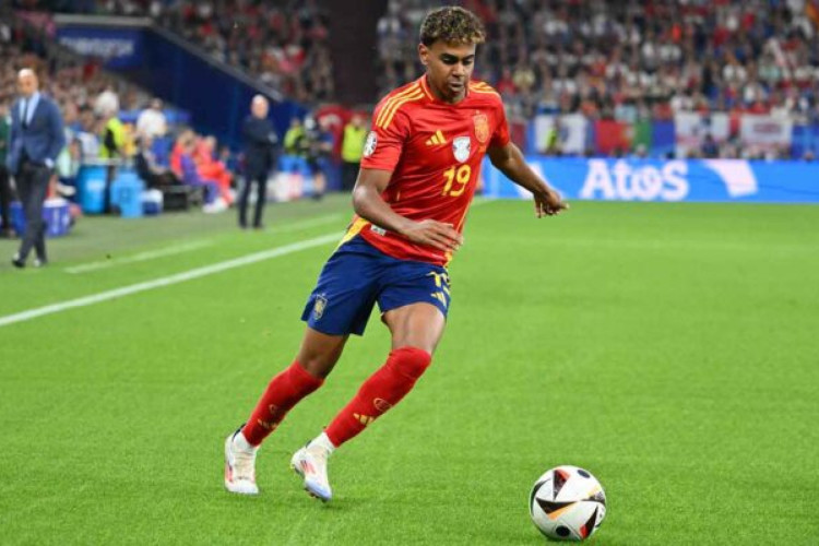 Spain's forward #19 Lamine Yamal runs with the ball during the UEFA Euro 2024 Group B football match between Spain and Italy at the Arena AufSchalke in Gelsenkirchen on June 20, 2024. (Photo by Alberto PIZZOLI / AFP) (Photo by ALBERTO PIZZOLI/AFP via Getty Images)