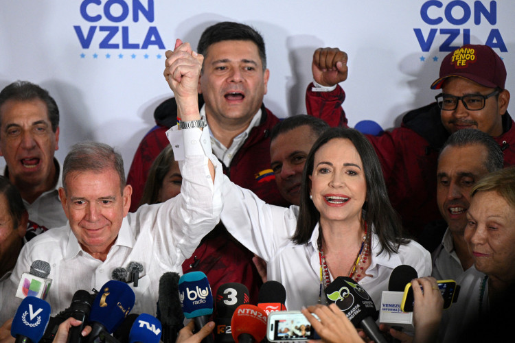 Venezuelan opposition leader Maria Corina Machado (R) speaks with the media next to opposition presidential candidate Edmundo Gonzalez Urrutia while waiting for the results of the presidential election, in Caracas on July 28, 2024. Venezuela's opposition leader Maria Corina Machado urged voters in the country's presidential election to remain at their polling stations to verify the counting process in the 