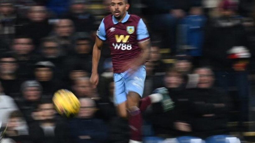 Burnley's Brazilian defender #22 Vitinho runs with the ball during the English Premier League football match between Burnley and Liverpool at Turf Moor in Burnley, north-west England on December 26, 2023. (Photo by Paul ELLIS / AFP) / RESTRICTED TO EDITORIAL USE. No use with unauthorized audio, video, data, fixture lists, club/league logos or 'live' services. Online in-match use limited to 120 images. An additional 40 images may be used in extra time. No video emulation. Social media in-match use limited to 120 images. An additional 40 images may be used in extra time. No use in betting publications, games or single club/league/player publications. /  (Photo by PAUL ELLIS/AFP via Getty Images)