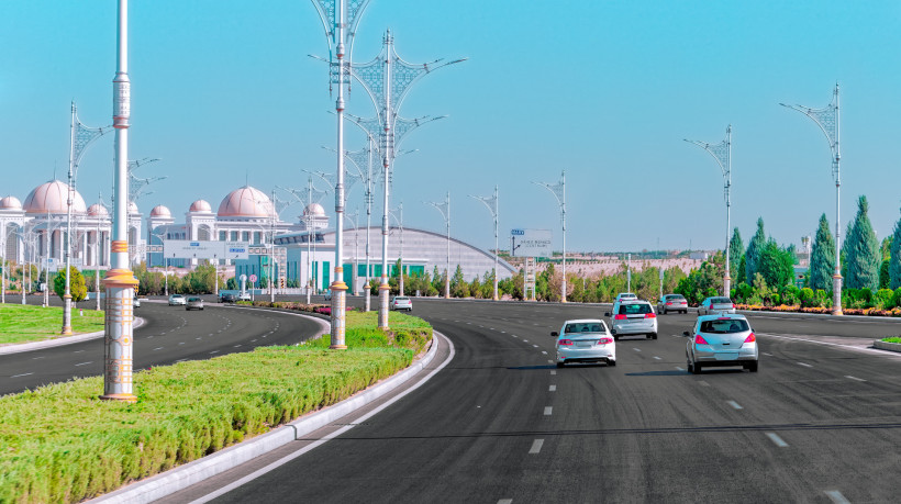 Tráfego de baixa intensidade de Ashgabat em estradas com arranha-céus de mármore branco ao fundo