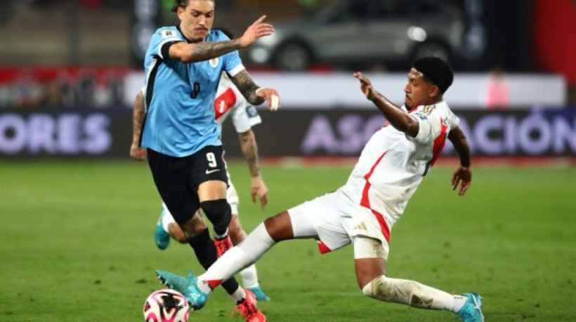 LIMA, PERU - OCTOBER 11: Darwin Núñez of Uruguay and Jesus Castillo of Peru battle for the ball during the FIFA World Cup 2026 South American Qualifier match between Peru and Uruguay at Estadio Nacional de Lima on October 11, 2024 in Lima, Peru. (Photo by Raul Sifuentes/Getty Images)