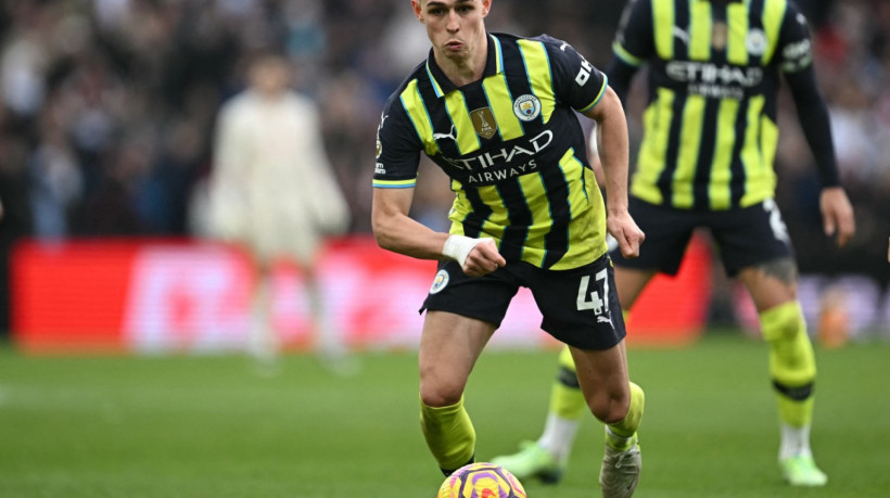 Manchester City's English midfielder #47 Phil Foden runs with the ball during the English Premier League football match between Aston Villa and Manchester City at Villa Park in Birmingham, central England on December 21, 2024.