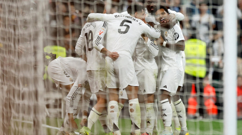 Real Madrid's players celebrate their fourth goal scored by Moroccan forward #21 Brahim Diaz during the Spanish league football match between Real Madrid CF and Sevilla FC at the Santiago Bernabeu stadium in Madrid on December 22, 2024.