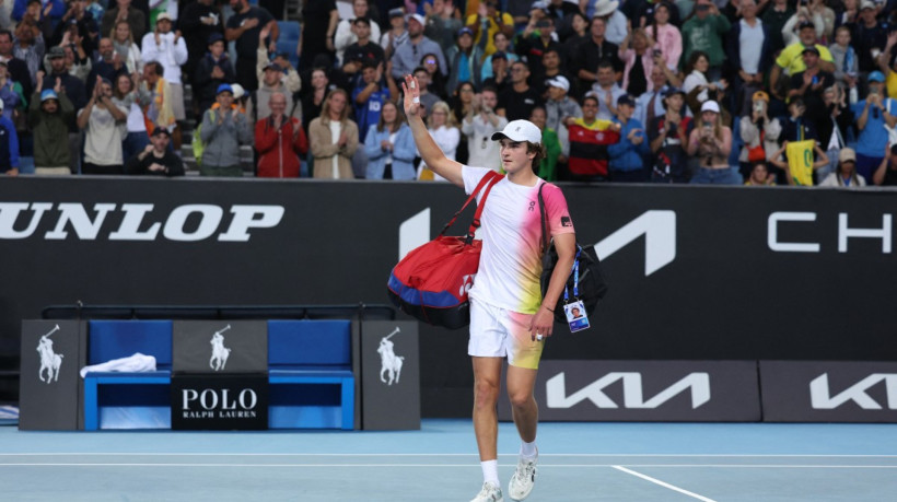 Brazil's Joao Fonseca leaves the court after defeat against Italy's Lorenzo Sonego during their men's singles match on day five of the Australian Open tennis tournament in Melbourne on January 16, 2025.