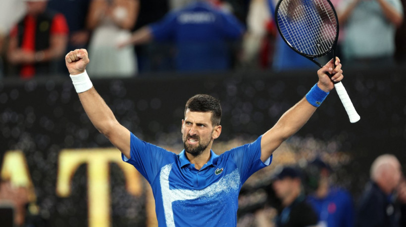 Serbia's Novak Djokovic celebrates victory over Spain's Carlos Alcaraz after their men's singles quarterfinal match on day ten of the Australian Open tennis tournament in Melbourne on January 22, 2025.