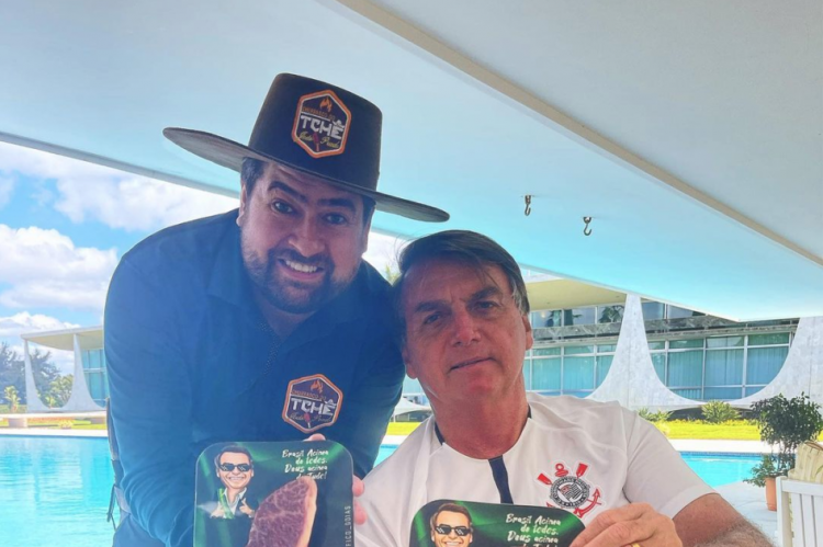 Presidente Bolsonaro ao lado de churrasqueiro dos artistas com picanha que custa R$ 1,799,99 o quilo, segundo a coluna Cozinha Bruta